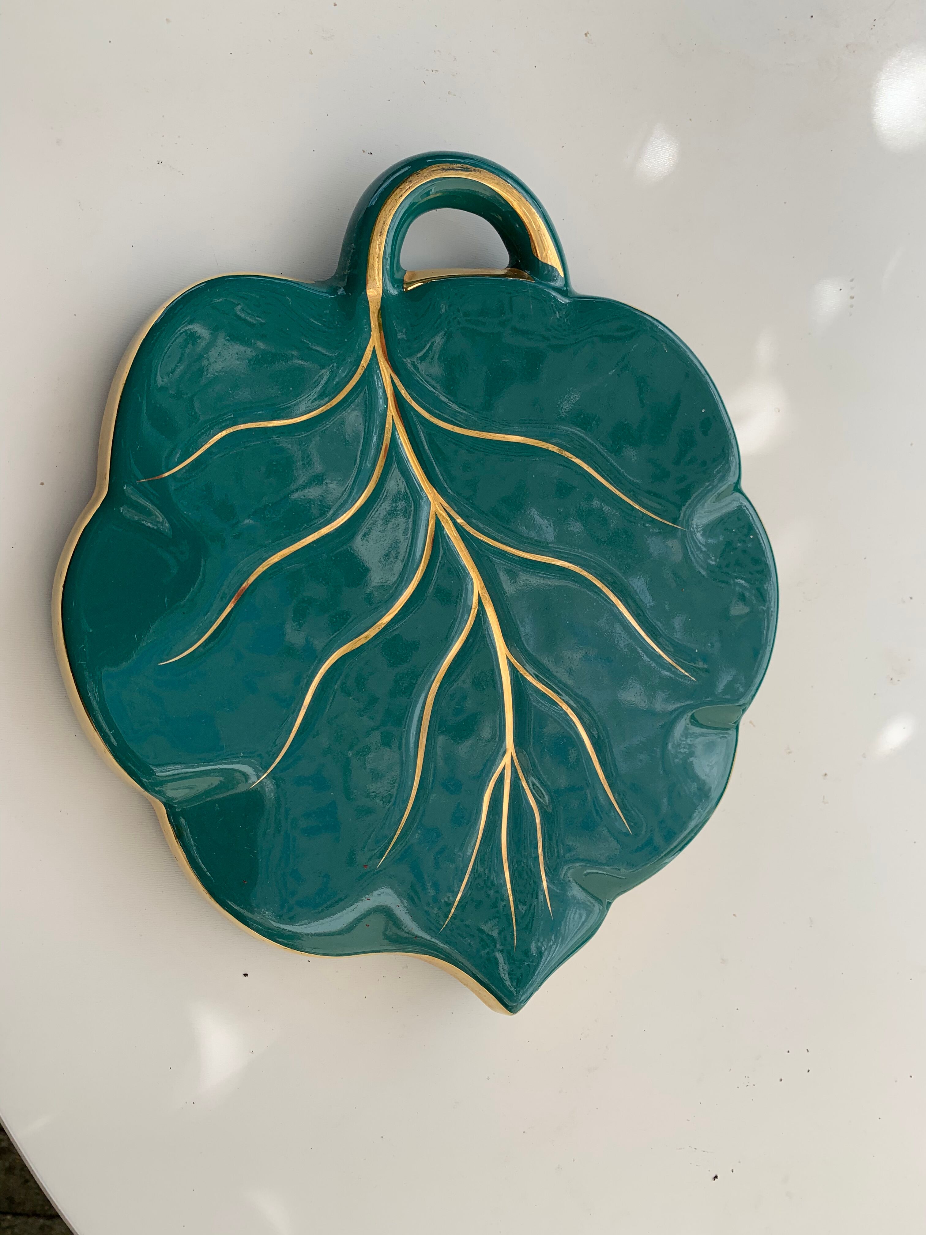 Grained in the shape of vintage dark green enamelled ceramic sheet