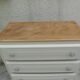Vintage commode enhanced in beige, wooden top.