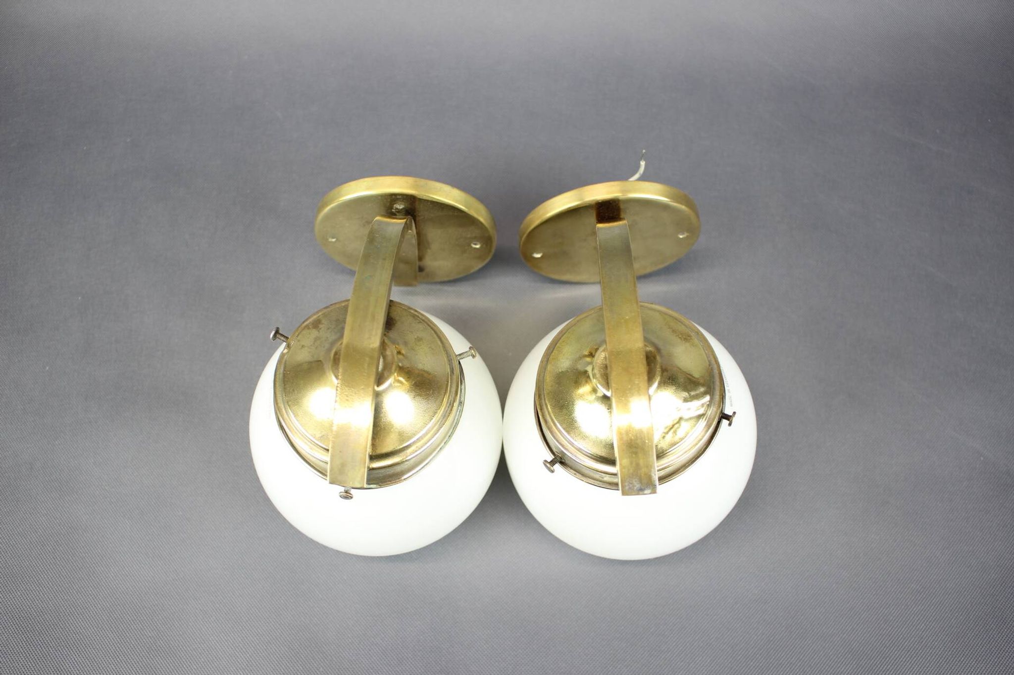 Pair of Art Deco wall sconces in brass and opaline glass, Europe, 1930s