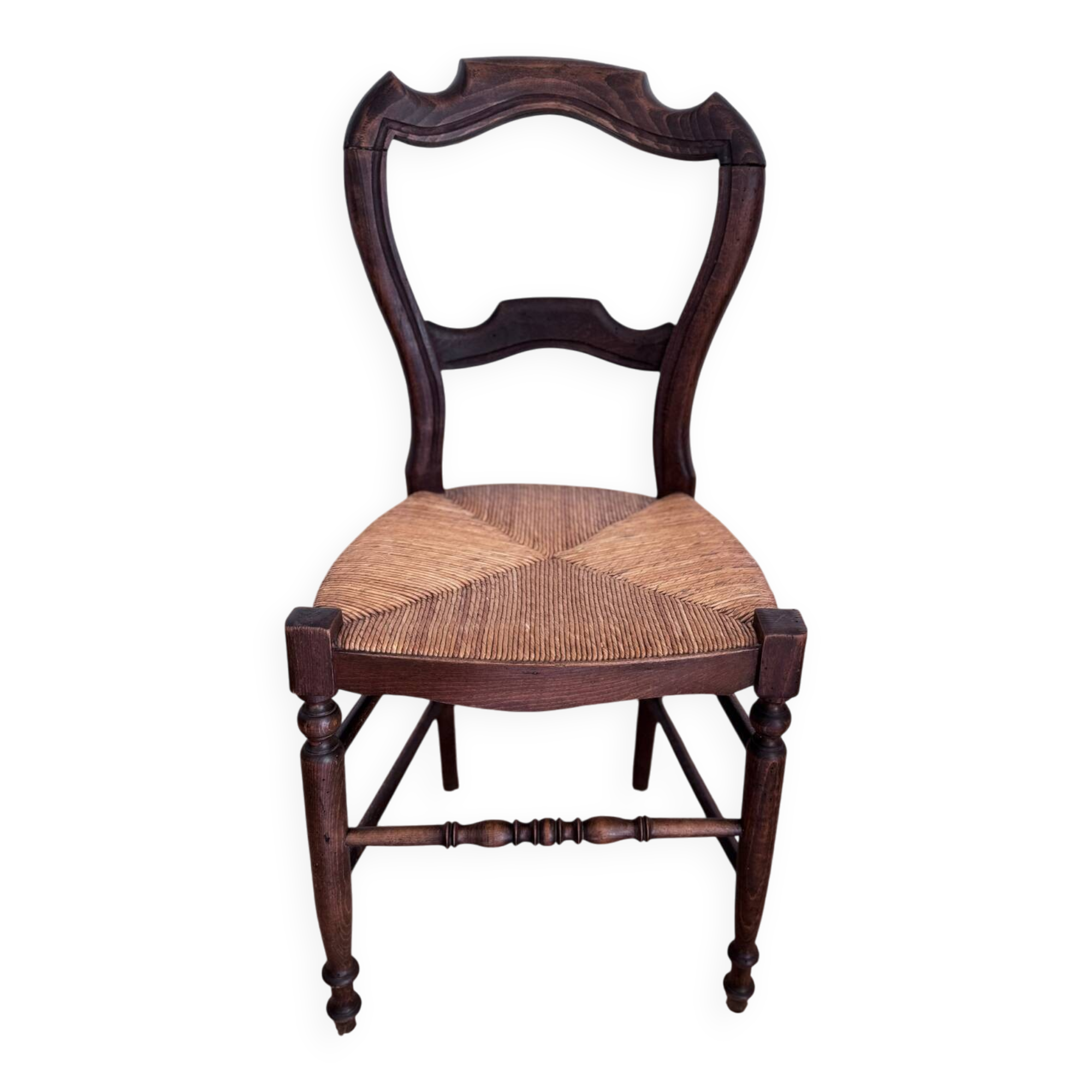 Antique wooden chairs with rush seating.