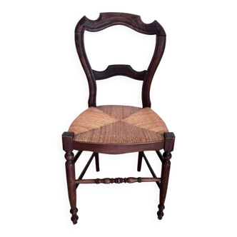 Antique wooden chairs with rush seating.