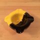 Two-tone ceramic ashtray in yellow and black, vintage 1950s.