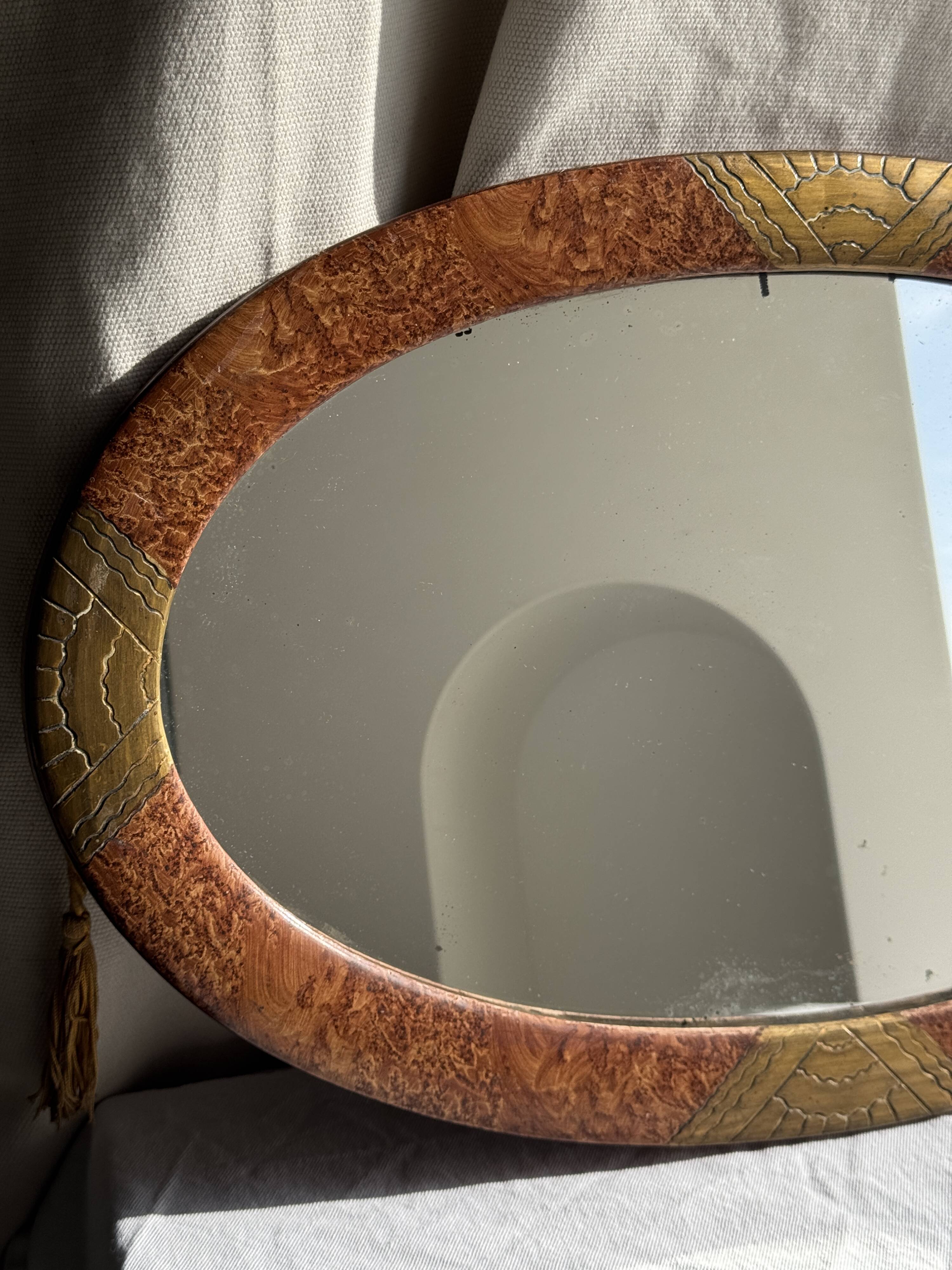 Small oval Art Deco mirror in brown and gold 33x54.