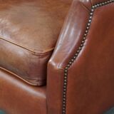 Cowhide armchair in good condition, finished with decorative nails