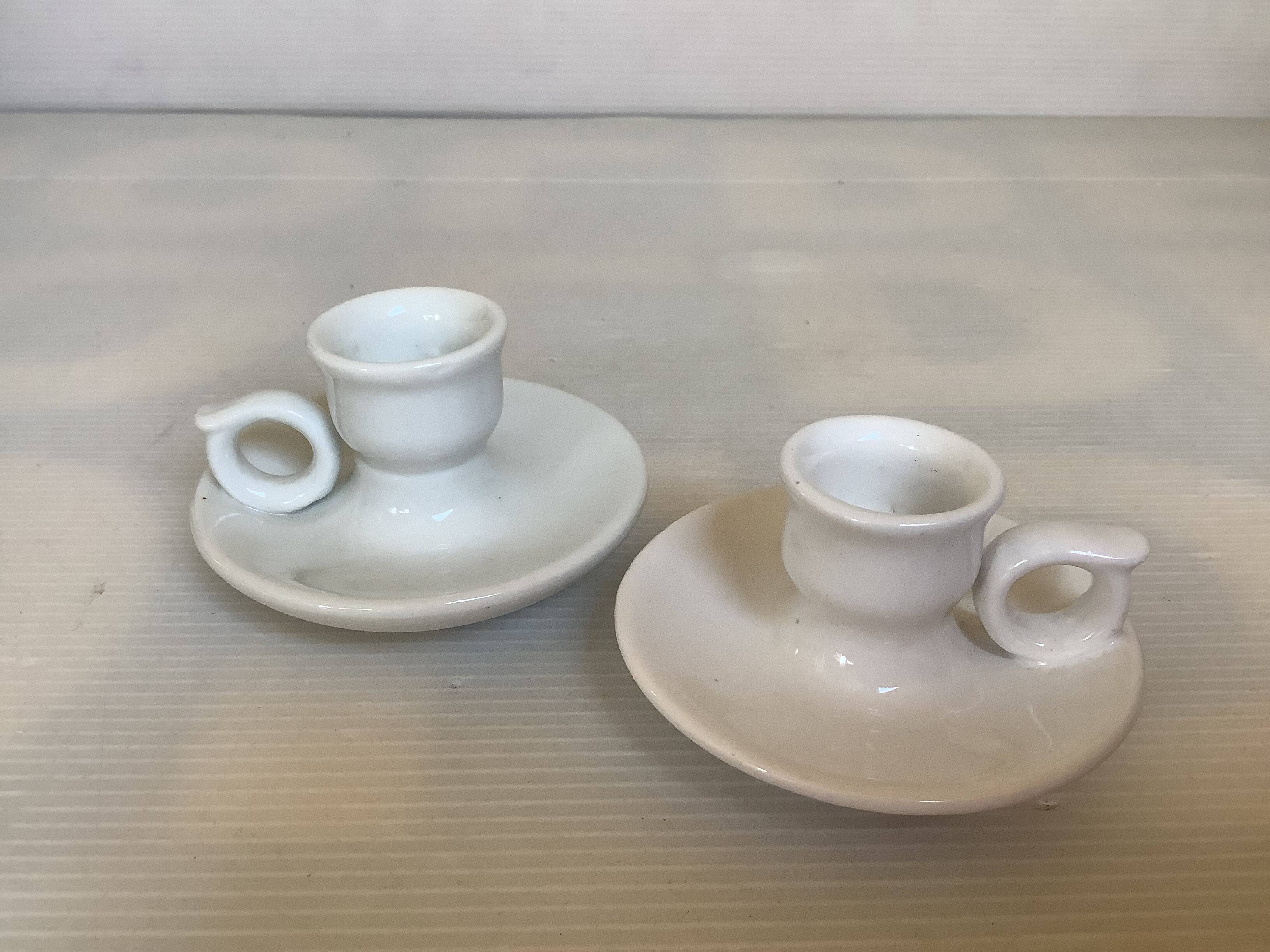 Pair of small white cellar rat candlesticks