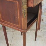 Old wooden bedside table on marble top