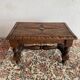 Low stool in carved wood