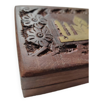 Old wooden box carved with flowers and brass