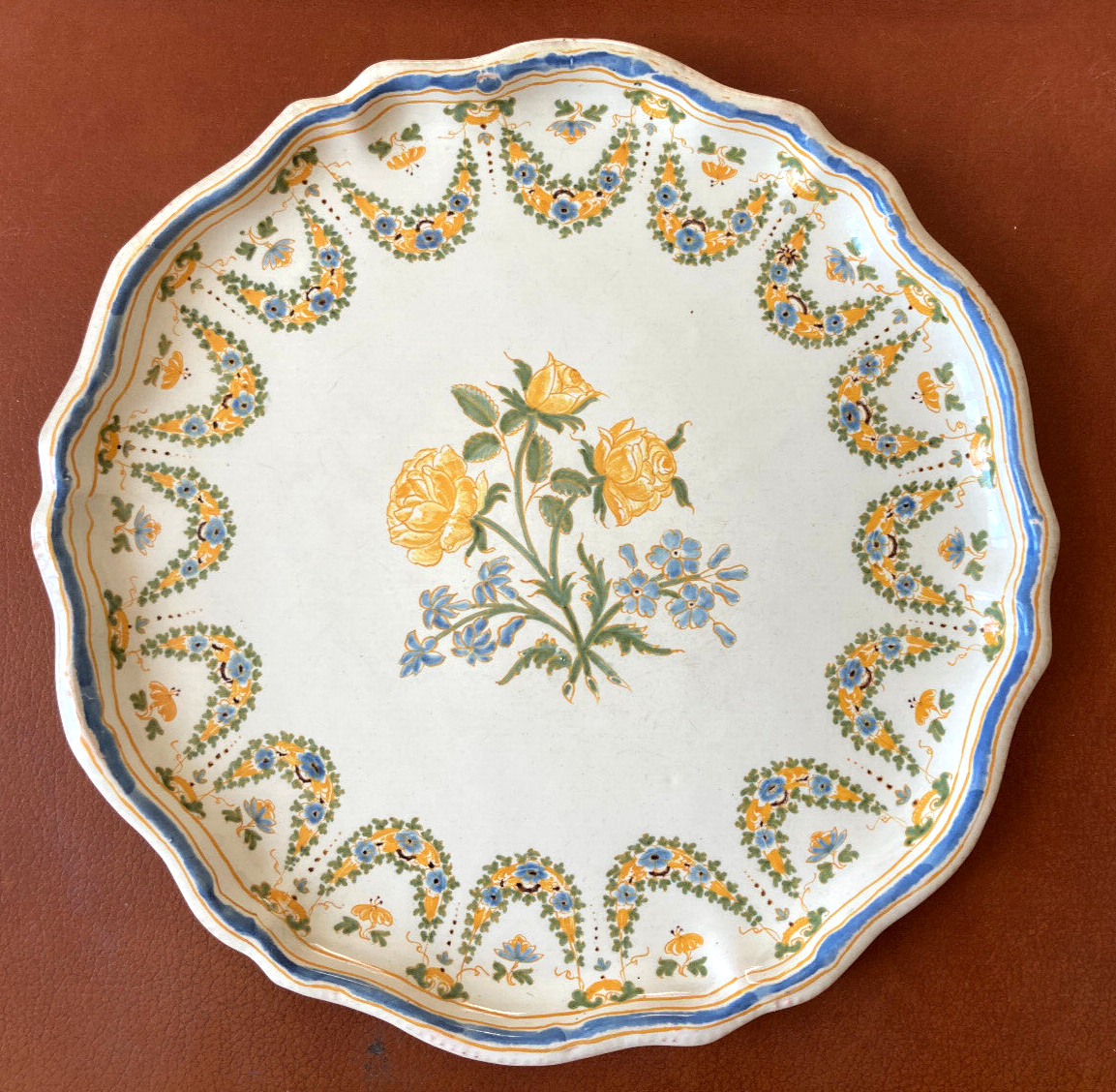 Old round dish in Lyon faience decorated with yellow roses