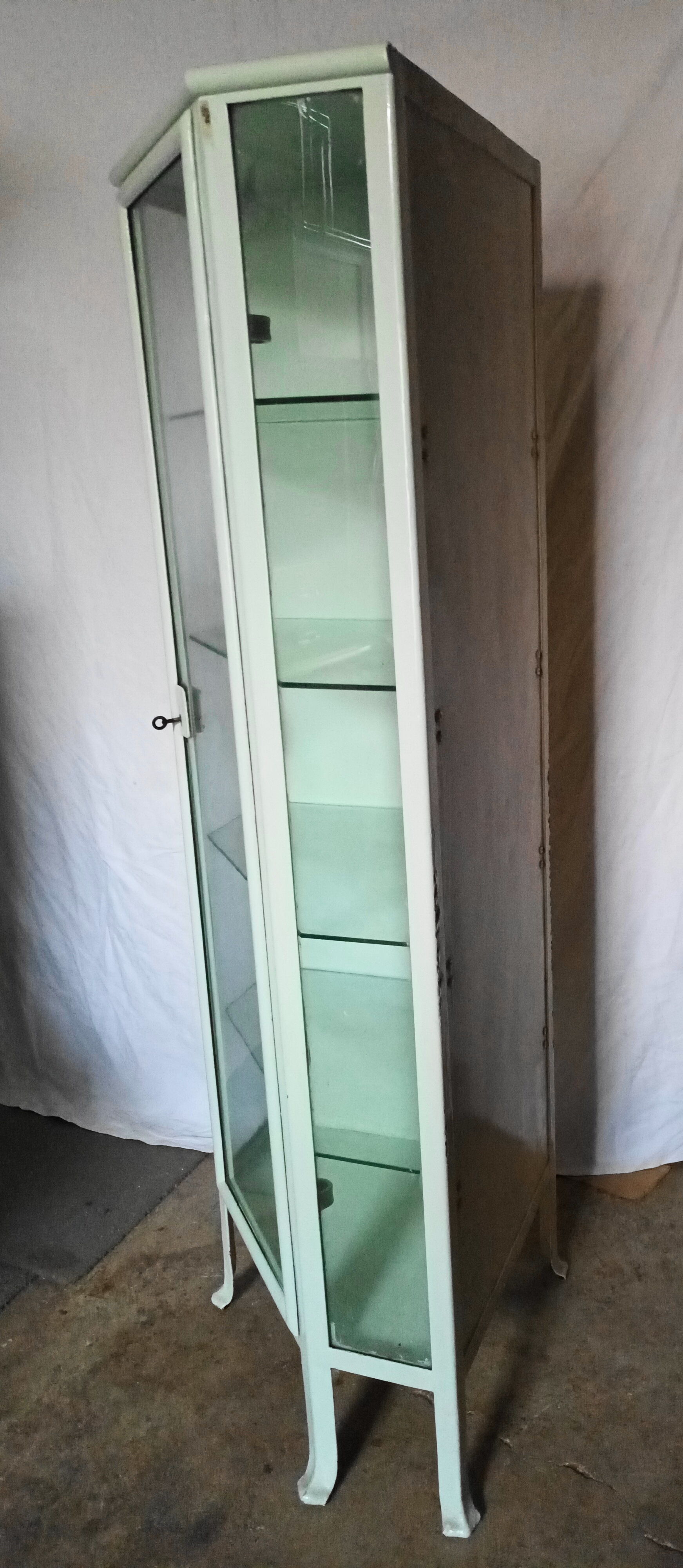 Painted metal ophthalmologist's corner display case, early 20th century