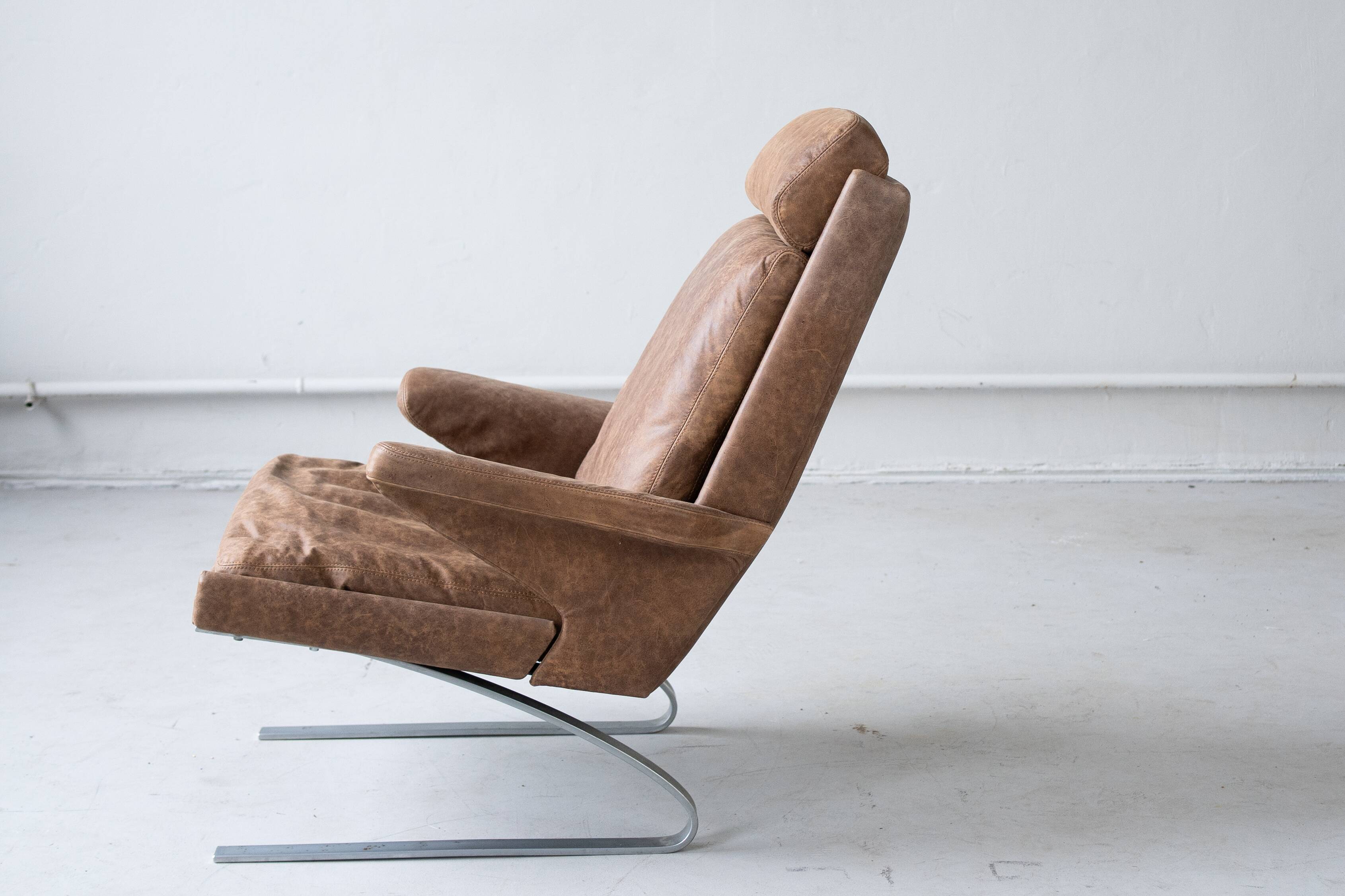 Vintage swing armchair and stool in leather by reinhold adolf for cor, 1970s, set of 2