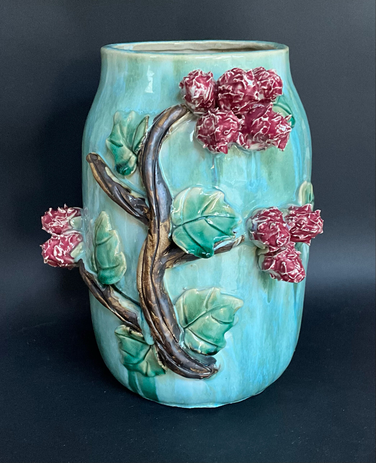 Large turquoise ceramic vase Athezza with raised floral decoration.