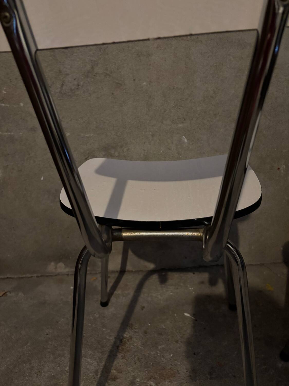 3 white Formica chairs