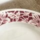 Round serving dish with burgundy red floral pattern