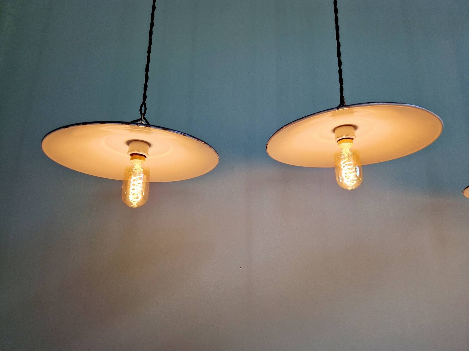 Three industrial suspensions in black enamelled sheet metal.