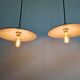 Three industrial suspensions in black enamelled sheet metal.