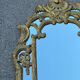 Large mirror with carved and gilded wooden frame, in Regency style.