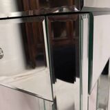 Bedside table covered with beveled mirrors on all sides