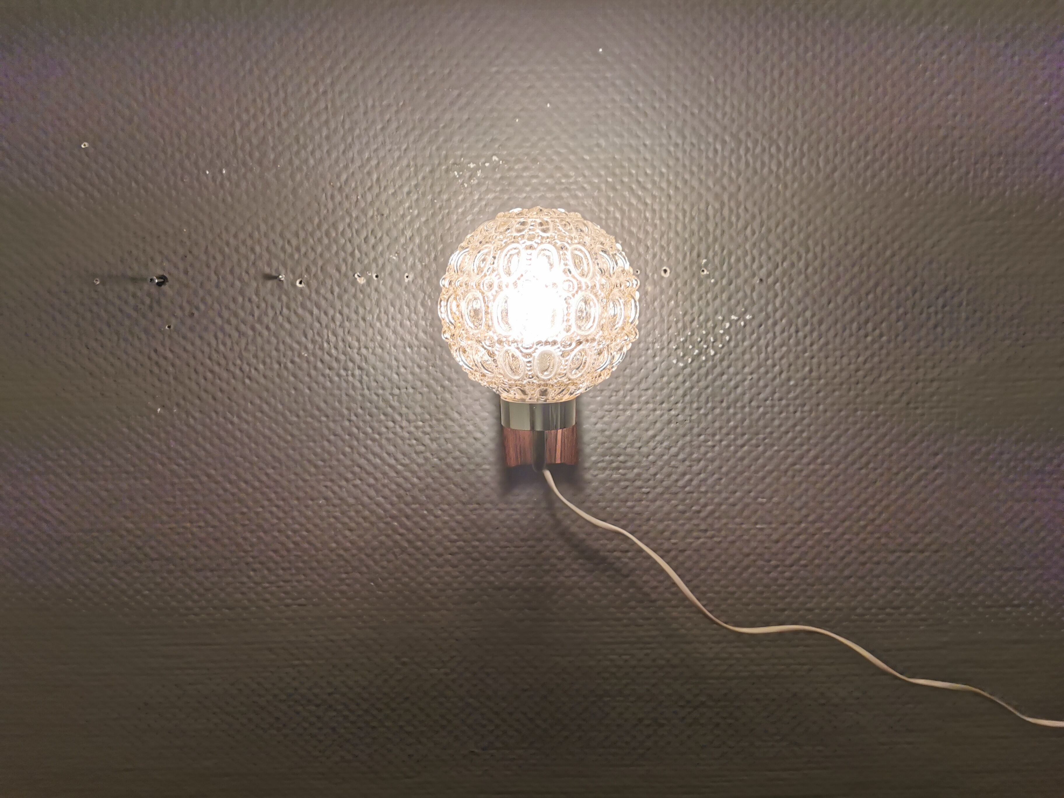 Wall light in rosewood with bobble glass ball shade.