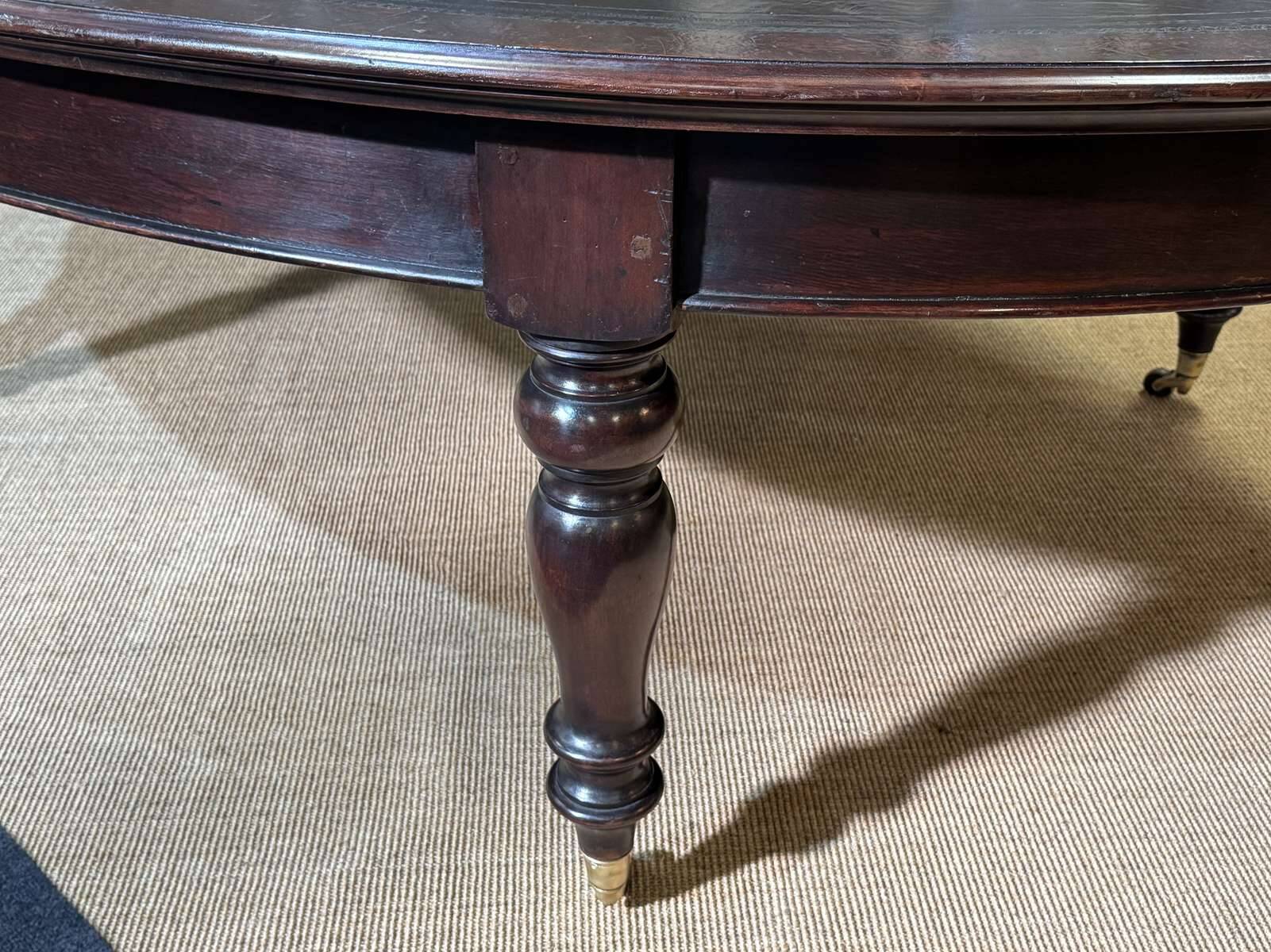 Large English library table in dark walnut with a leather top.