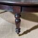 Large English library table in dark walnut with a leather top.
