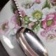 12 small Christofle Marly silver-plated spoons in the mascaron pattern.