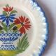 Pair of antique plates in popular earthenware with a floral basket decoration on the edge.