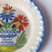 Pair of antique plates in popular earthenware with a floral basket decoration on the edge.