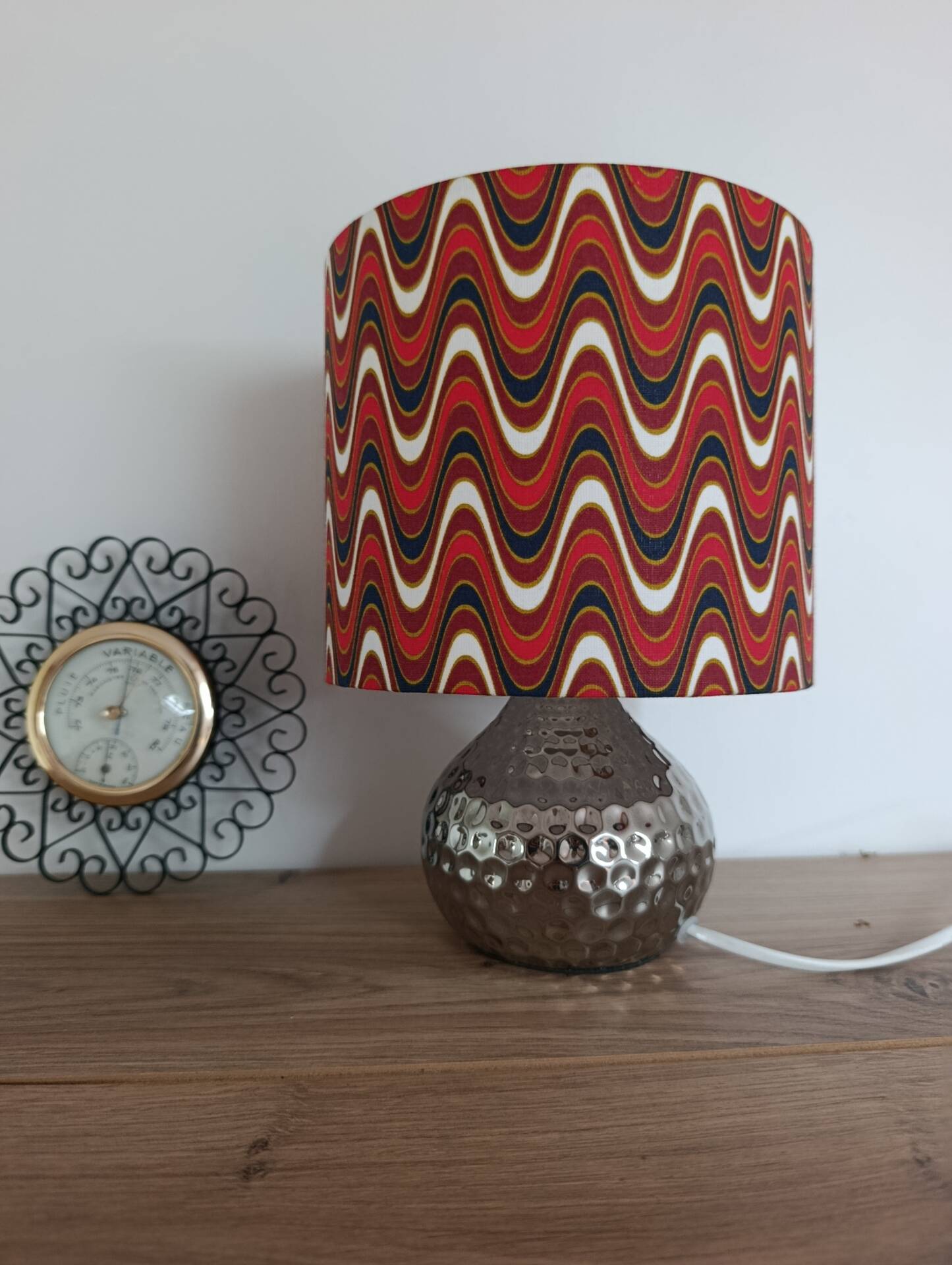 Vintage table lamp with printed shade featuring seventies waves.