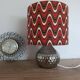 Vintage table lamp with printed shade featuring seventies waves.