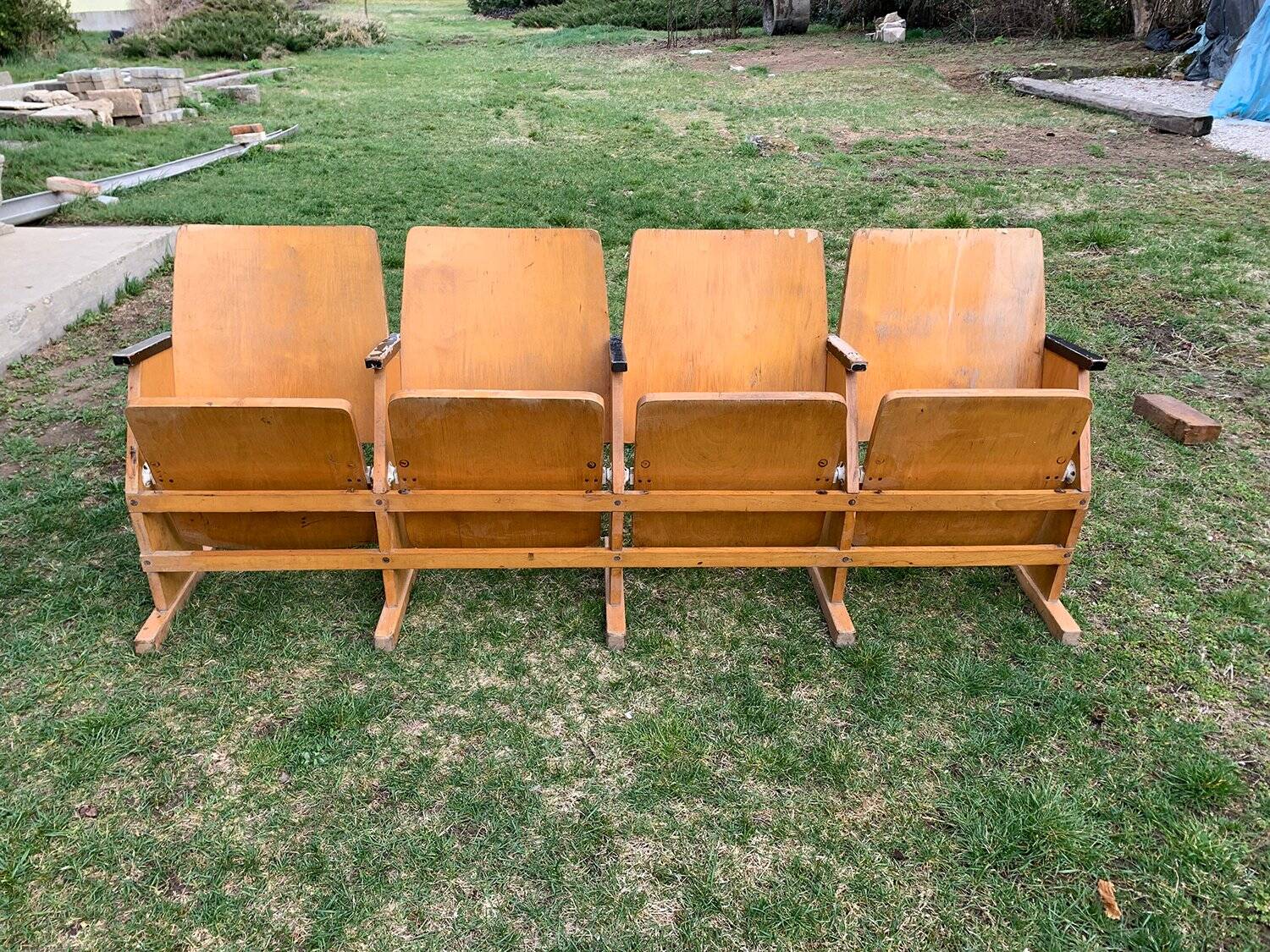 Vintage cinema bench for four people, brown varnished beech in Mid-Century style from the 1950s.