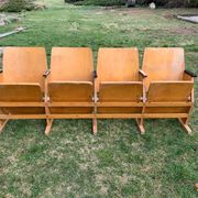 Vintage cinema bench for four people, brown varnished beech in Mid-Century style from the 1950s.