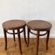2 antique bistro stools with curved wood and caning effect.