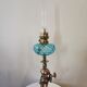 Large kerosene lamp mounted on bronze statue. Late nineteenth century