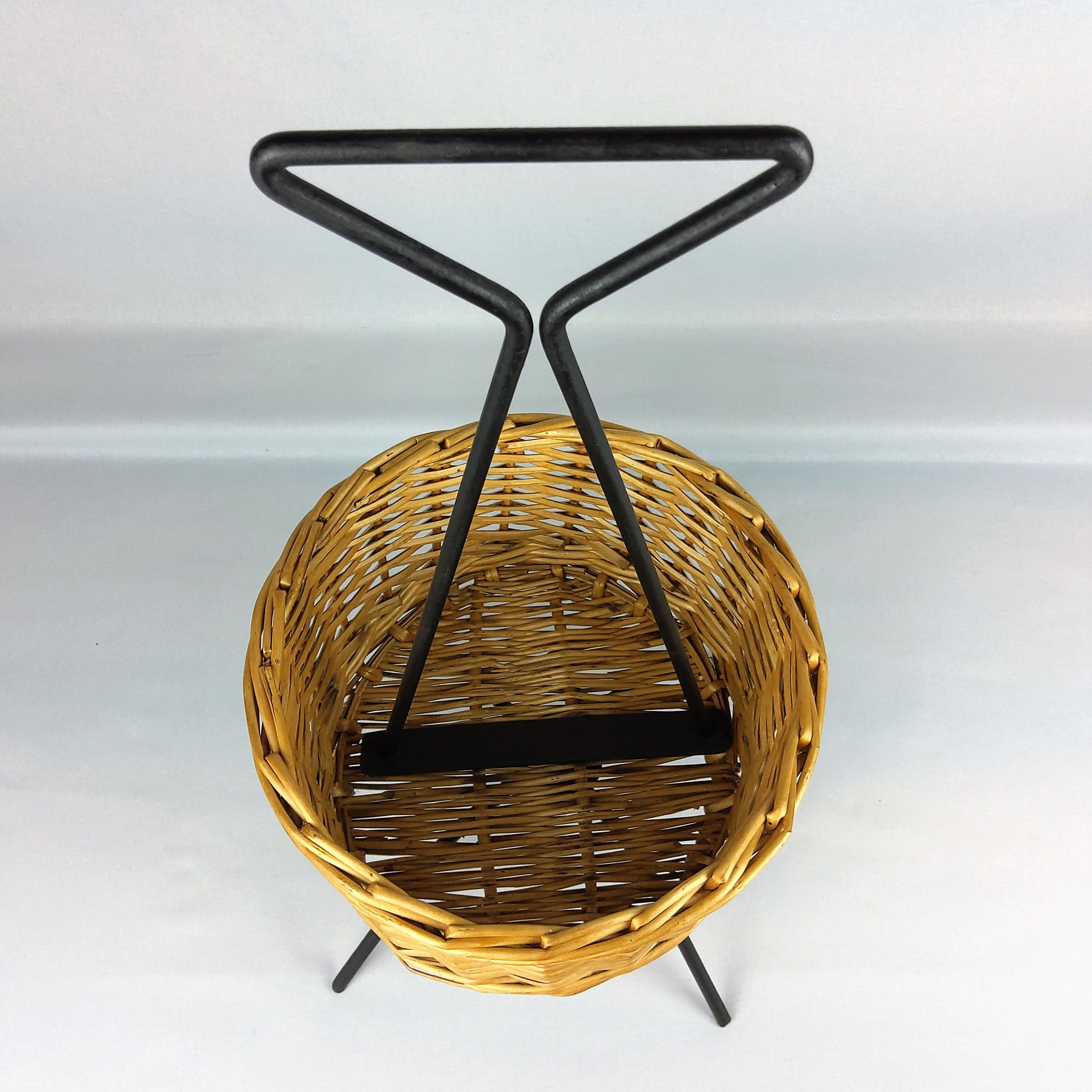 Black metal rattan trash can on 1960