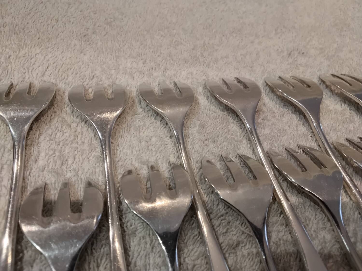 12 silver-plated oyster forks by silversmith J Brille with stick handles.