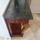Empire/Restoration style console table with scrolled ends, mirrored back, and claw feet.