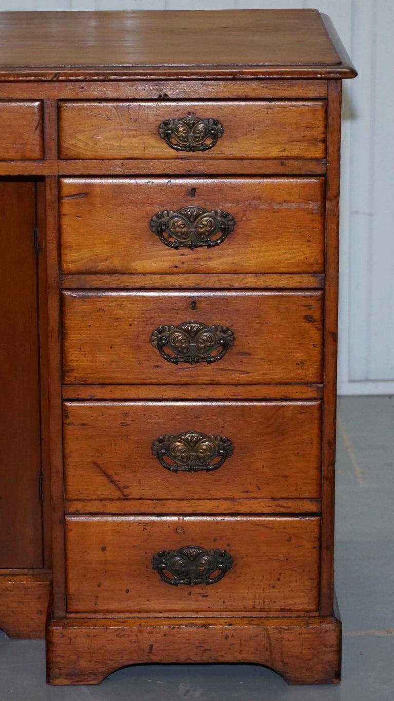 Small Victorian desk in solid walnut with drawers.