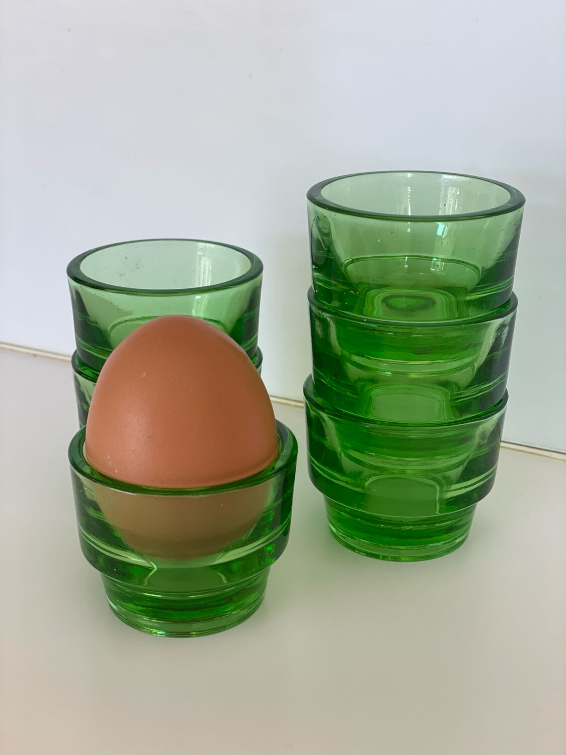 6 egg cups, green glass digestif glasses Lever.