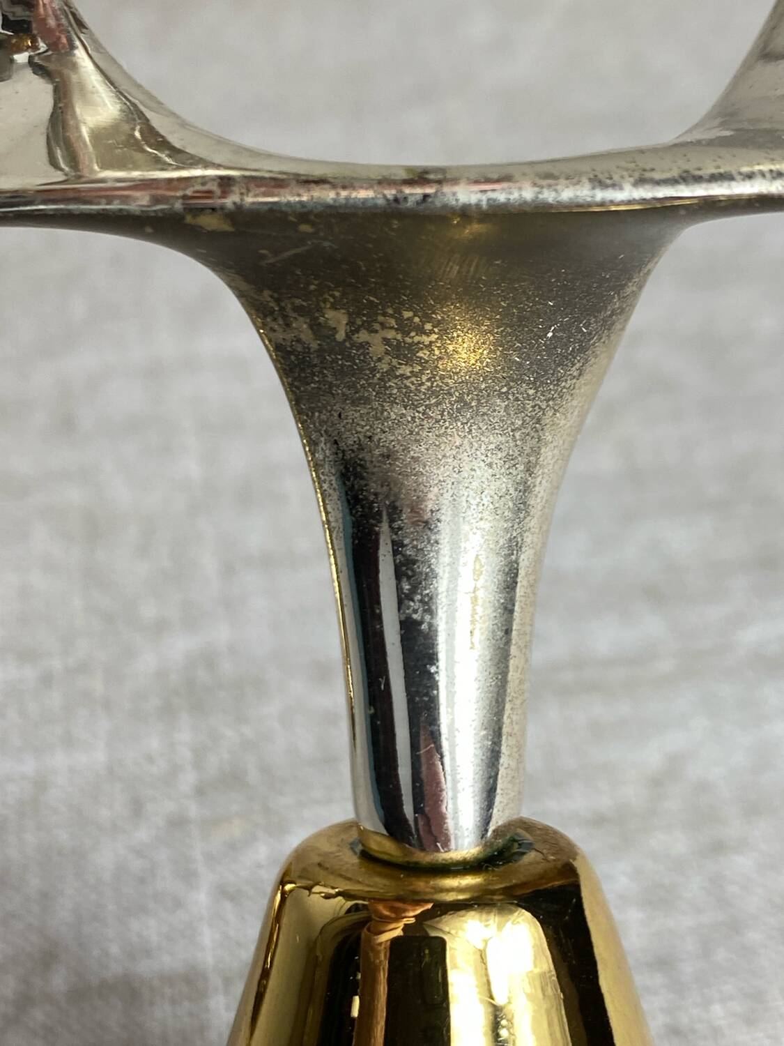Pair of silver and gold metal candlesticks