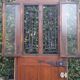 Oak entrance door and its frame and transom, wrought iron gates