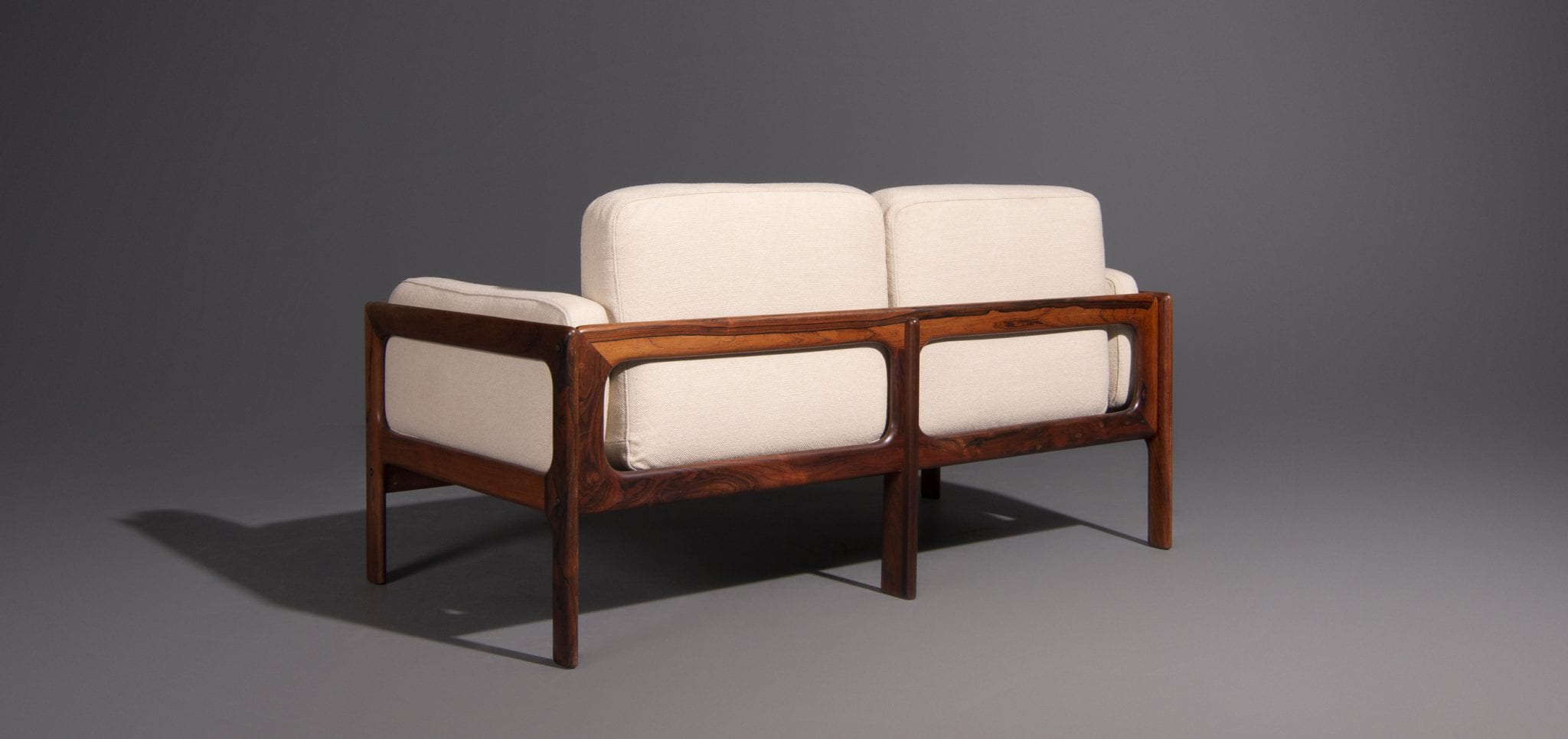Two-seater and rosewood armchair produced by Komfort