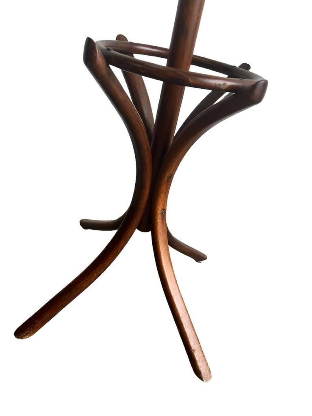 Vintage coat rack on floor in curved wood, thonet style