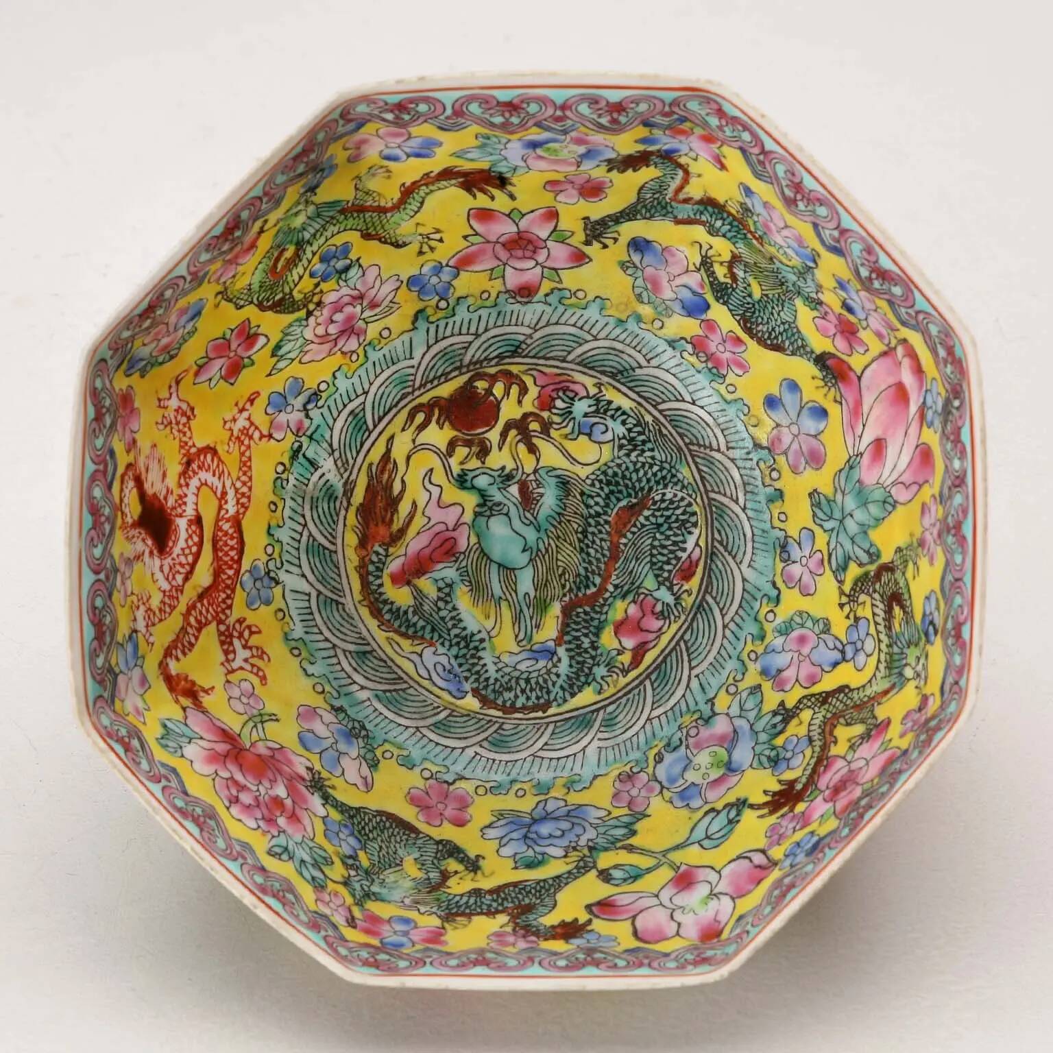 Vintage porcelain bowl decorated with dragons and flowers, China, 1980s.