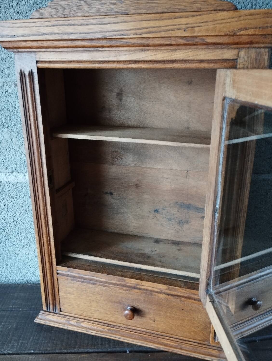 Old glass wall shelf with drawer door