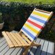 Folding chair in wood and striped fabric