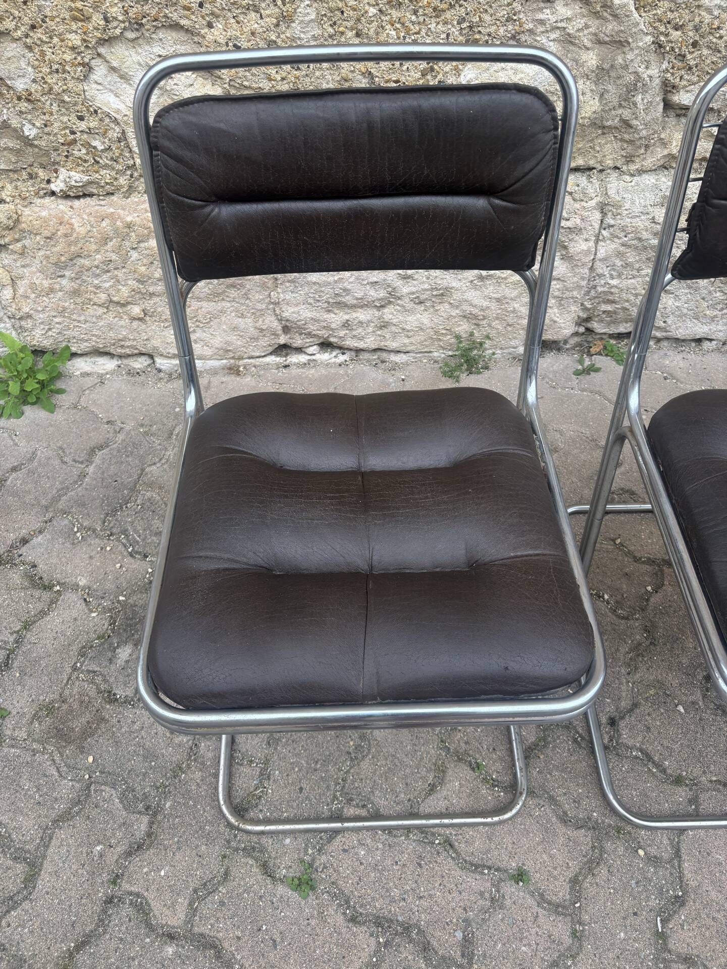Four vintage chairs from the 1960s and 1970s, chrome with faux leather.