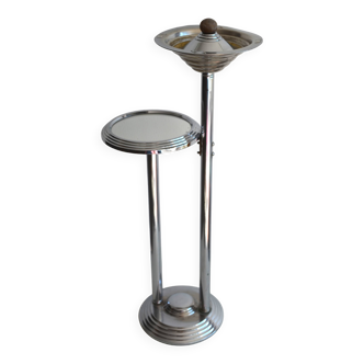 Ashtray and shelf on chrome metal stand.