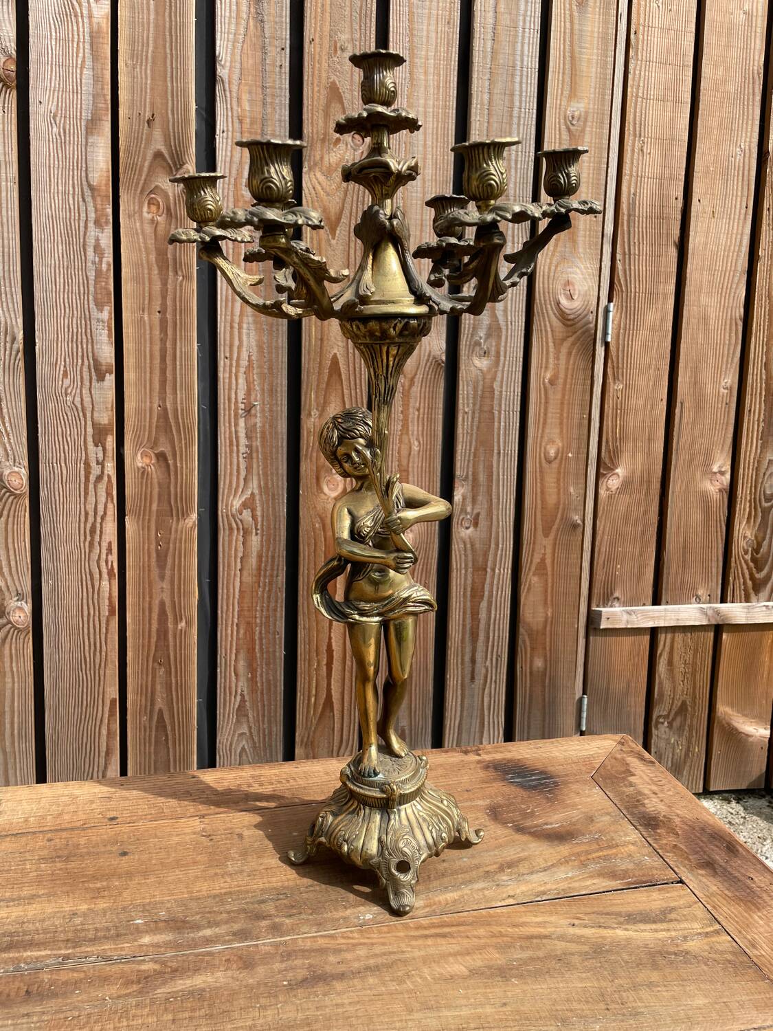 Large bronze candle holder with putti angel
