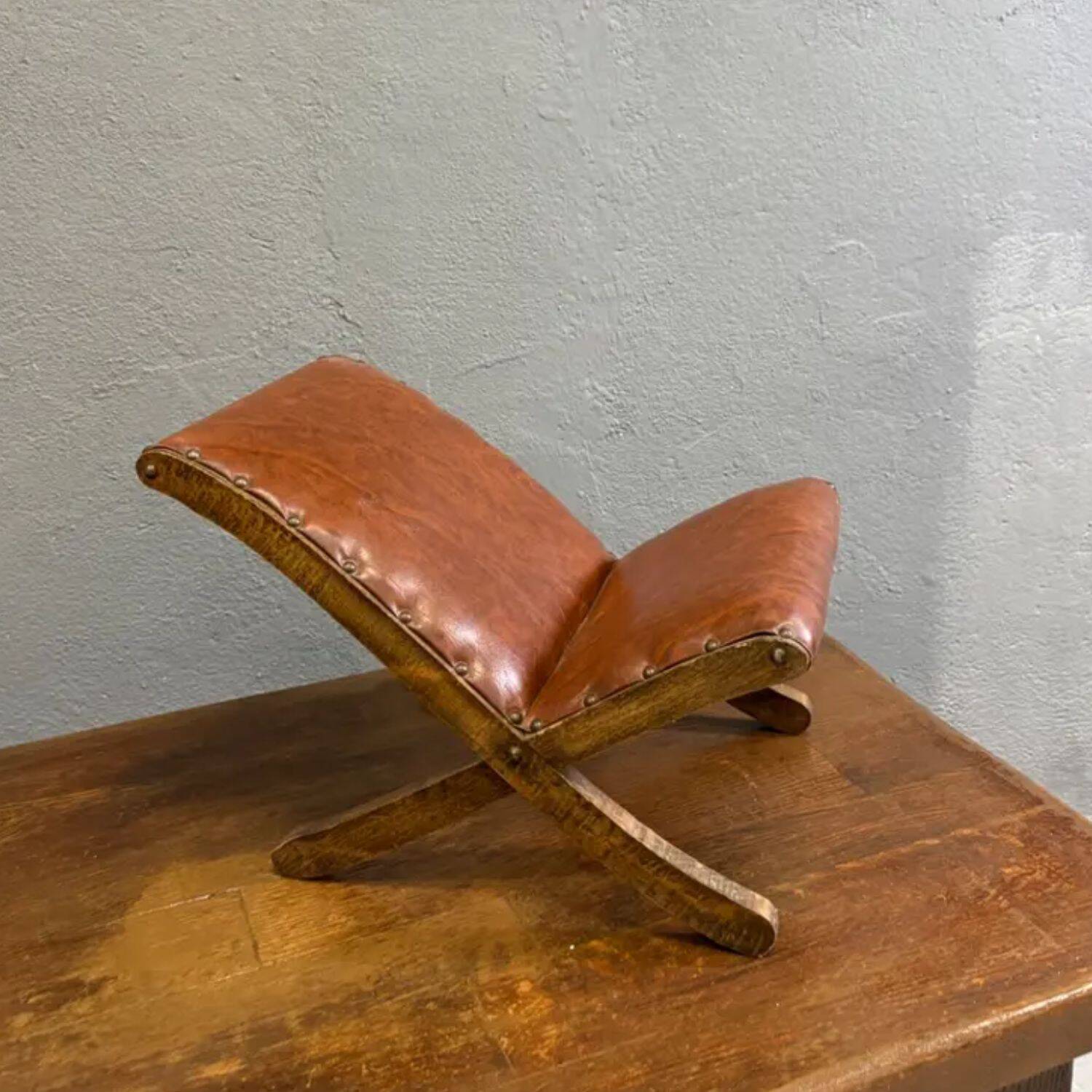 Old retro footstool, mid-century wooden leather stool, mid 20th century, European